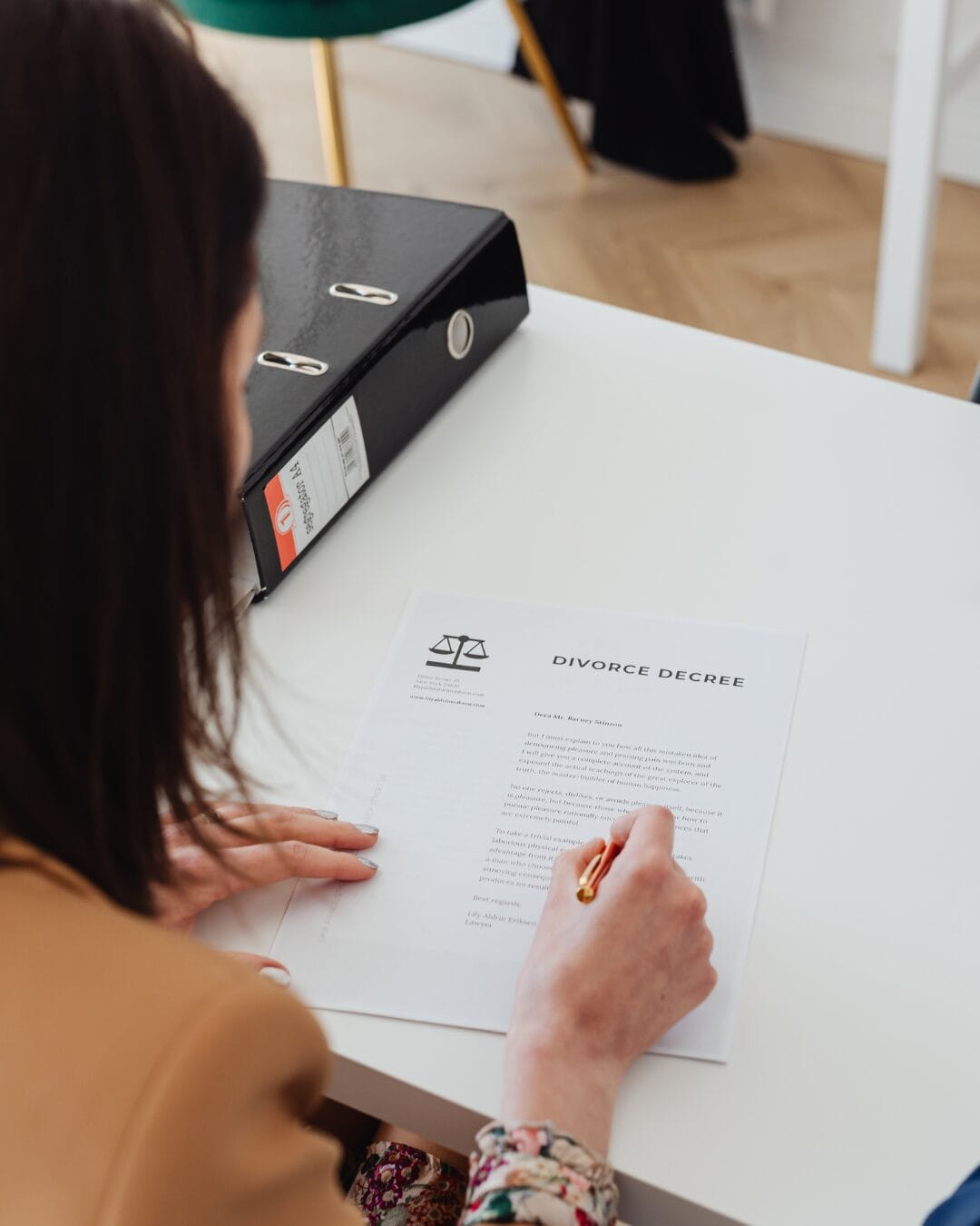 Woman signing a divorce decree